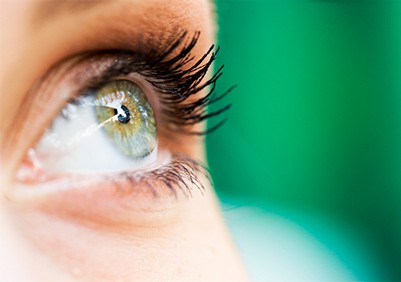 woman smiling after eyelid surgery